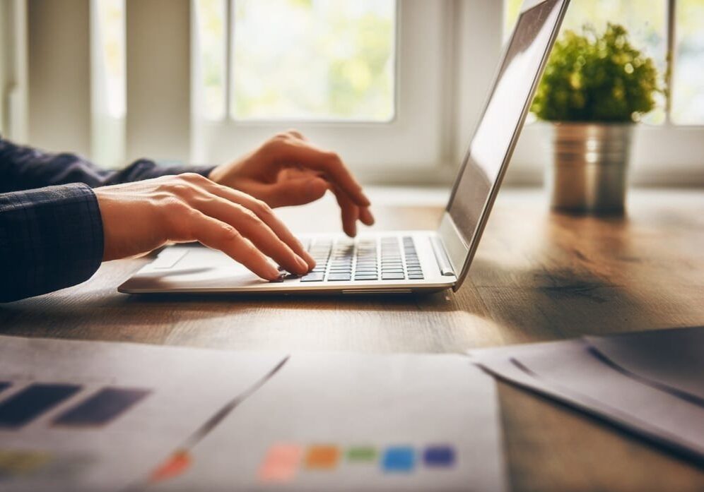 Woman using Laptop with graphs