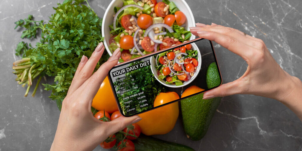 Person using smartphone to track nutrition facts and calories in her food