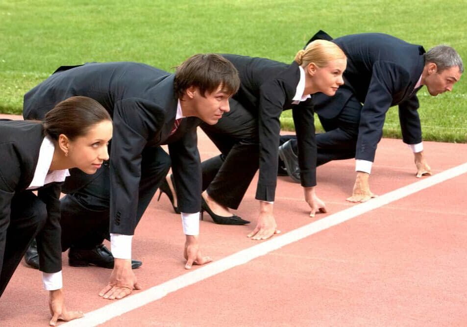 Business people lined up at track starting line