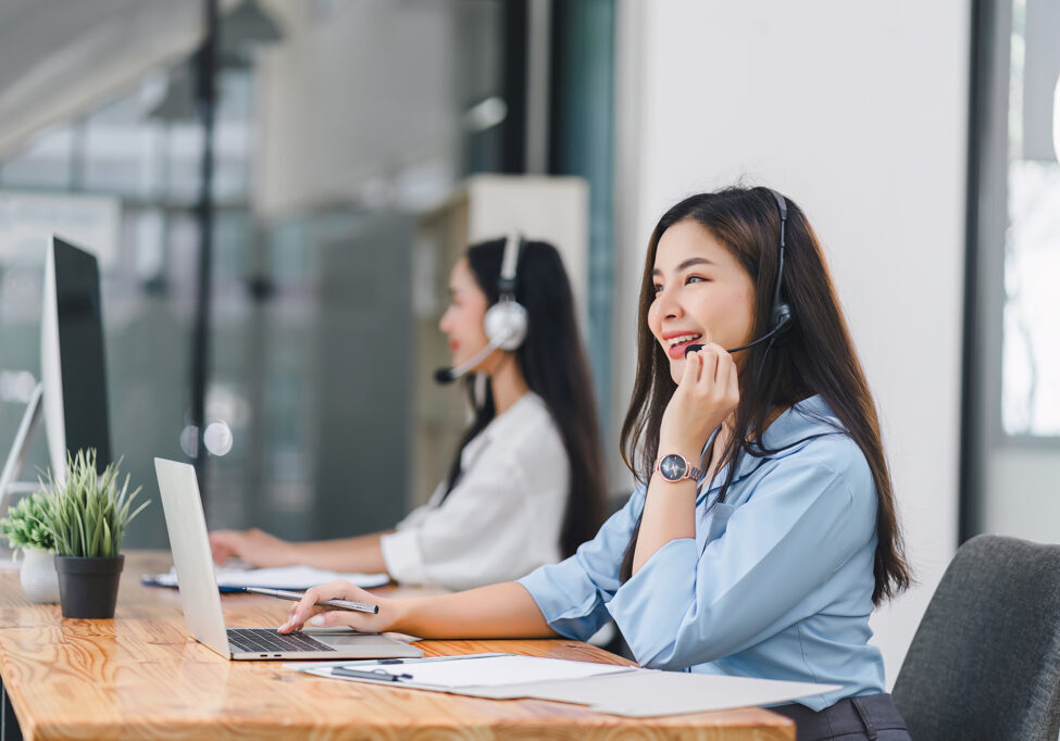 Smiling call center agents wearing headsets