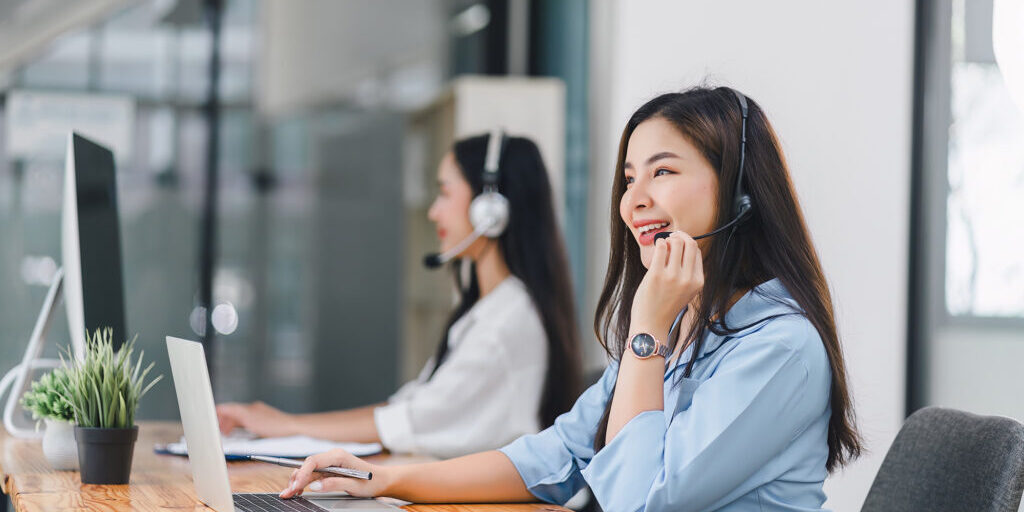 Smiling call center agents wearing headsets