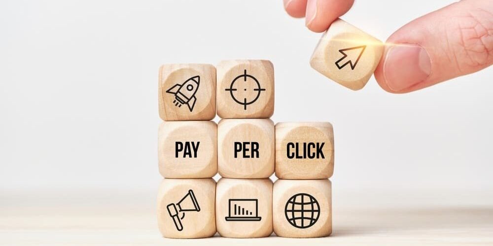 Person stacks wooden cubes from text and icons
