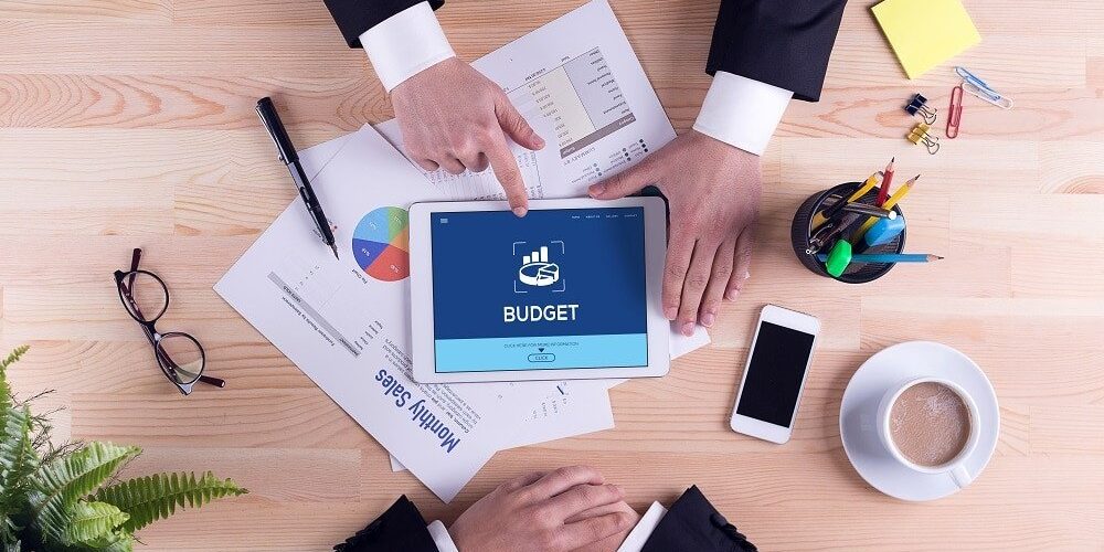 Business people using tablet for budgeting