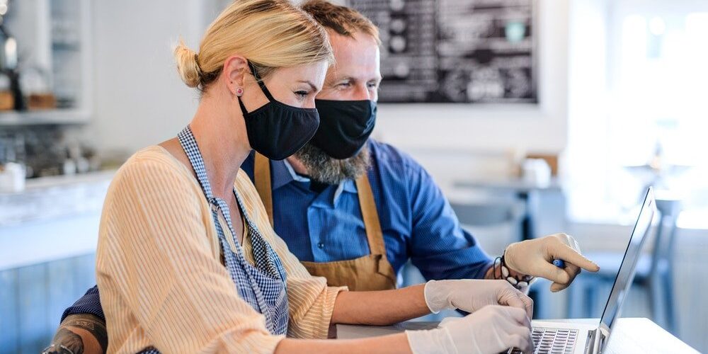Portrait of coffee shop owners with face masks, lockdown, quarantine, coronavirus, back to normal concept.