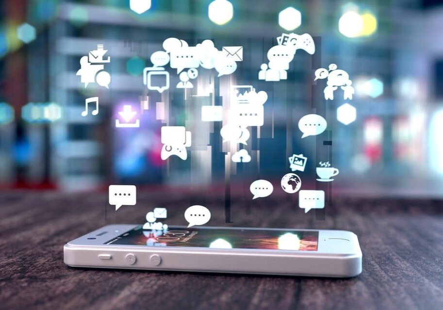 White smart phone with holographic image of social media