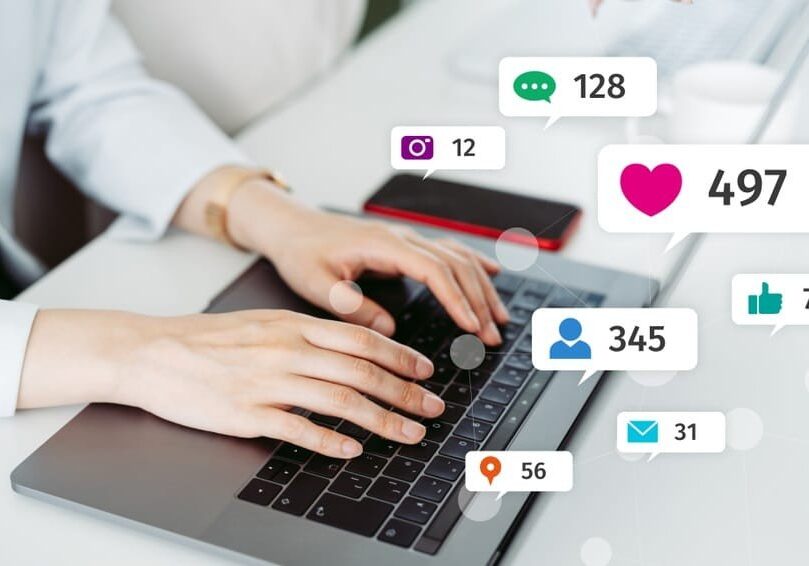 Typing on laptop promoting social media