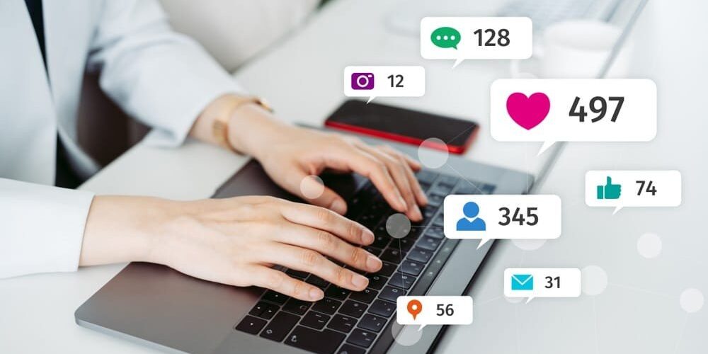 Typing on laptop promoting social media
